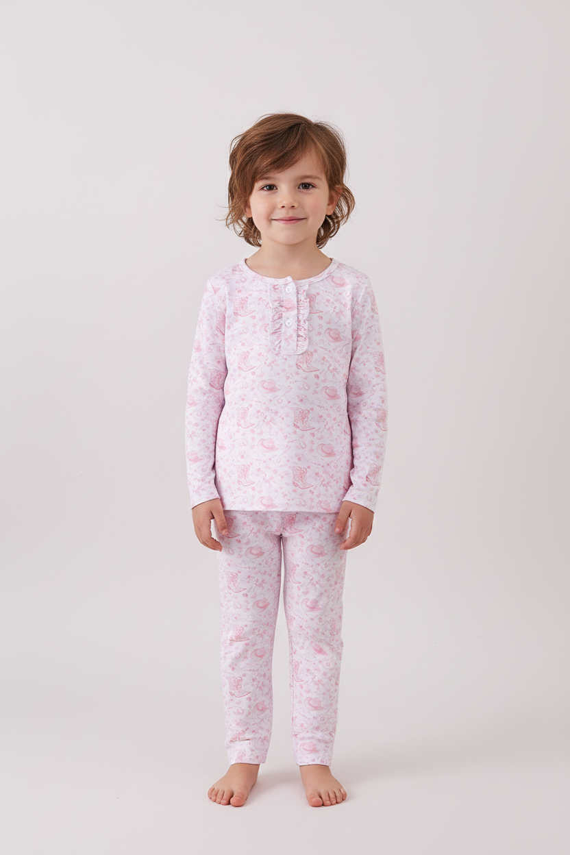 Child wearing pink floral pajamas on a white background